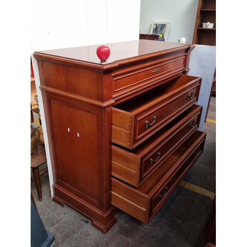 632 - A handsome red Mahogany chest of drawers with brass handles and detailed carvings.