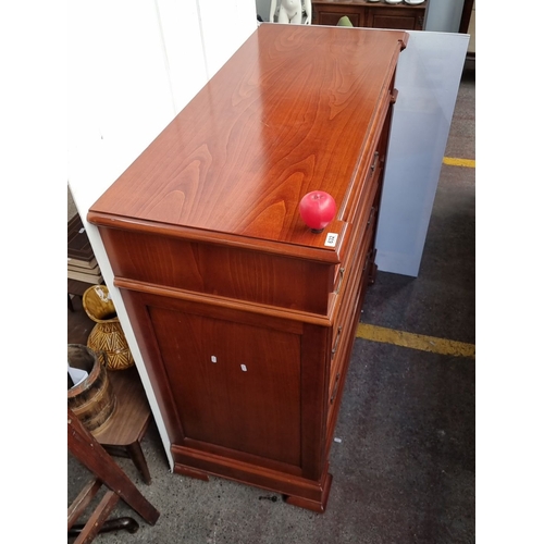 632 - A handsome red Mahogany chest of drawers with brass handles and detailed carvings.