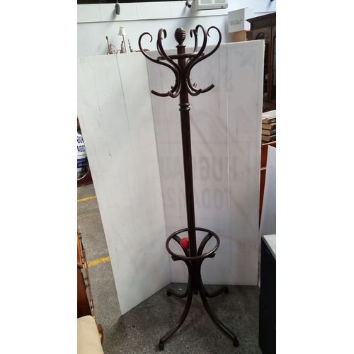 641 - Victorian-style dark wood coat stand with curved hooks and turned finial, featuring a circular base ... 