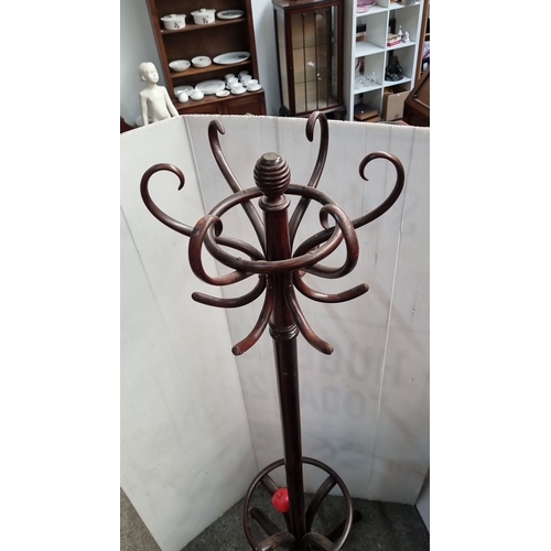 641 - Victorian-style dark wood coat stand with curved hooks and turned finial, featuring a circular base ... 