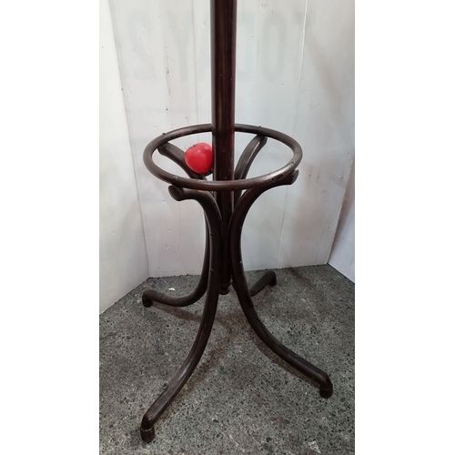 641 - Victorian-style dark wood coat stand with curved hooks and turned finial, featuring a circular base ... 