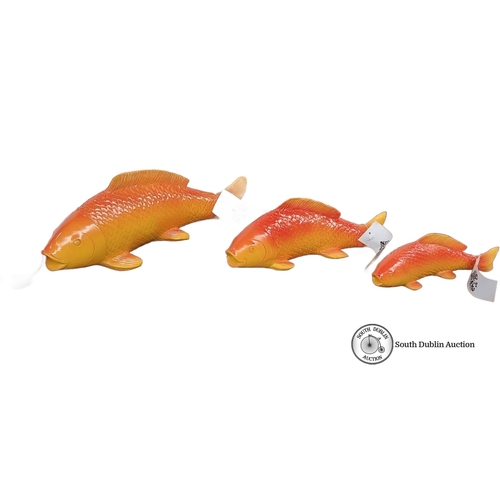 652 - Set of three decorative orange and yellow fish sculptures with mounting brackets, vibrant gradient f... 