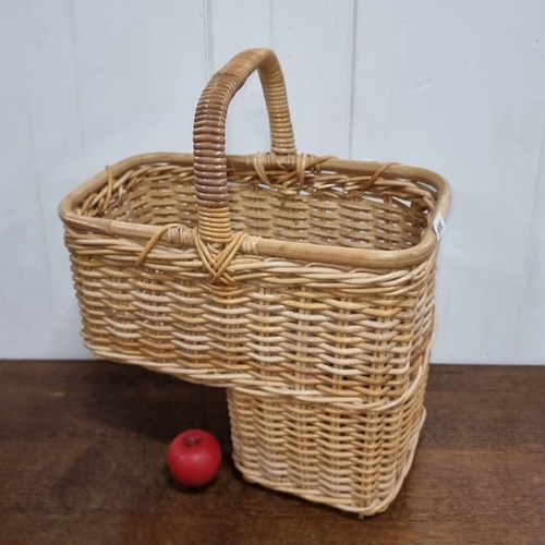 666 - Natural woven basket with rustic charm of this two-tiered wicker basket with a sturdy handle for a s... 