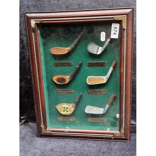 674 - Framed set of vintage style golf club heads displayed on green felt. Features labels identifying dif... 