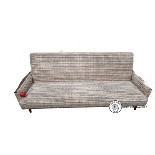 679 - Star Lot : Mid-Century Modern sofa with textured fabric upholstery and wooden armrests, reflecting 1... 