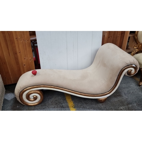 680 - Star Lot : Curved chaise longue with beige upholstery, ornamental gold-toned scroll detailing, and w... 