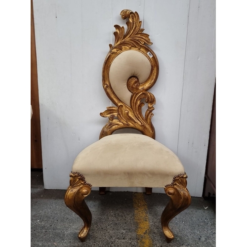 681 - A very tall Ornate Rococo-style chair with gilt wood frame and plush beige upholstery has intricatel... 