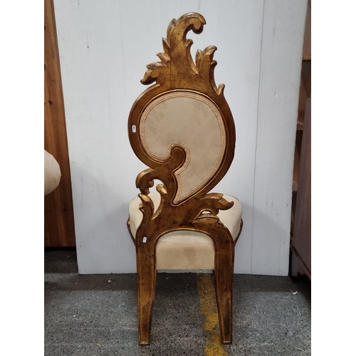 681 - A very tall Ornate Rococo-style chair with gilt wood frame and plush beige upholstery has intricatel... 