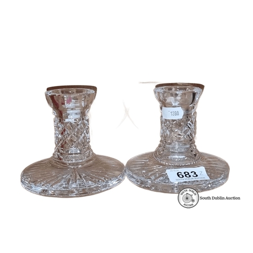 683 - Pair of Waterford crystal candlestick holders featuring elegant cut glass design.