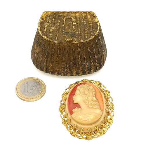 486 - Two items including a brass pendant in the form of a fishing creel (Dimensions - 6cm x 4cm / Weight ... 