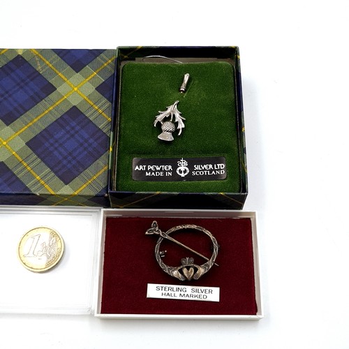 491 - A Scottish sterling silver torc brooch with claddagh design. Pin intact. Boxed. Together with a Scot... 