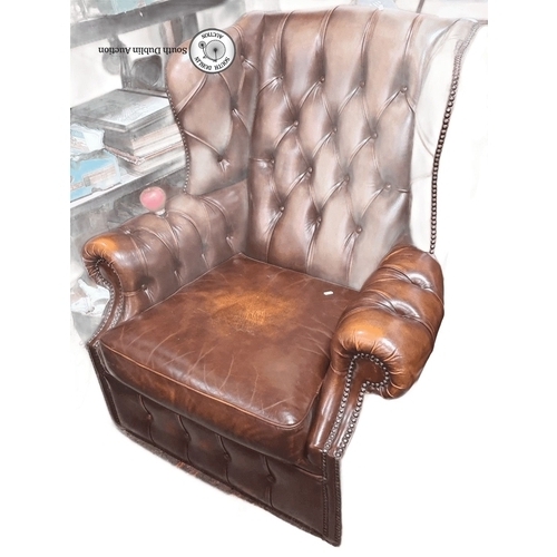 745 - Star lot : A Vintage Chesterfield leather armchair with deep button-tufted design and nailhead trim ... 