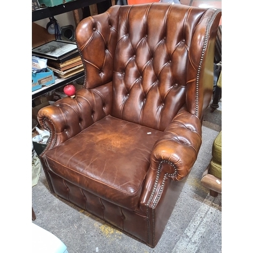 745 - Star lot : A Vintage Chesterfield leather armchair with deep button-tufted design and nailhead trim ... 