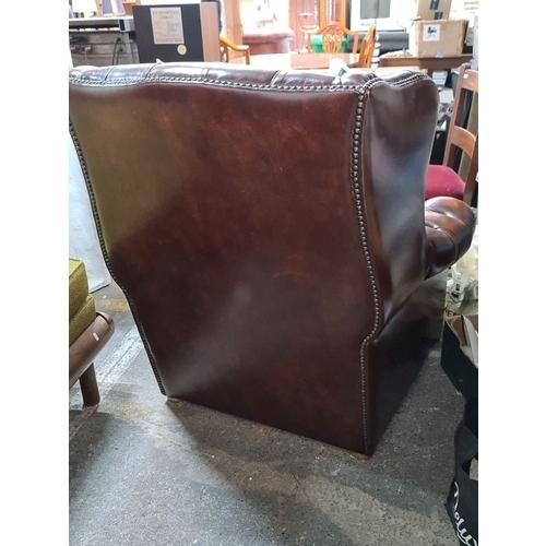 745 - Star lot : A Vintage Chesterfield leather armchair with deep button-tufted design and nailhead trim ... 