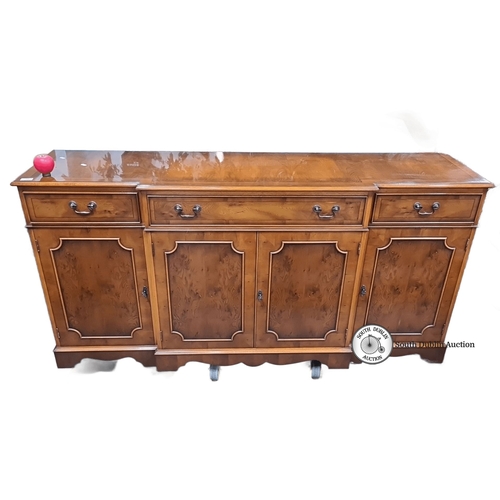 756 - A beautiful satinwood sideboard with four paneled doors and three drawers, featuring elegant hardwar... 