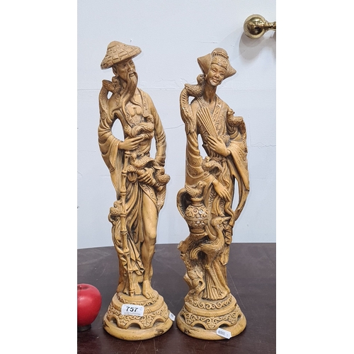 757 - Carved oriental figurines depict a man and woman with birds and intricate detailing. From the mid-20... 