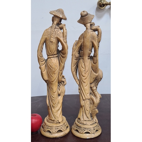 757 - Carved oriental figurines depict a man and woman with birds and intricate detailing. From the mid-20... 