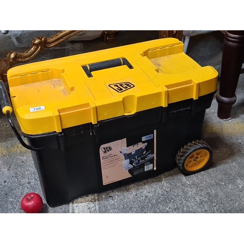 758 - A Large JCB mobile rolling toolbox with assorted tools, including a saw and tape measure. It has dur... 