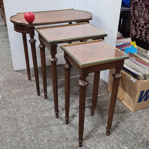 765 - Set of three nesting tables, from the early 20th century, featuring inlaid wood tops and turned legs... 