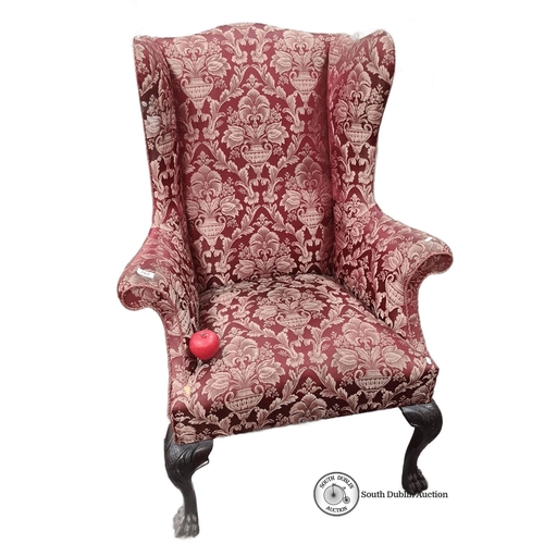 768 - Star Lot : Wingback armchair features ornately carved claw feet and is upholstered in rich red and g... 