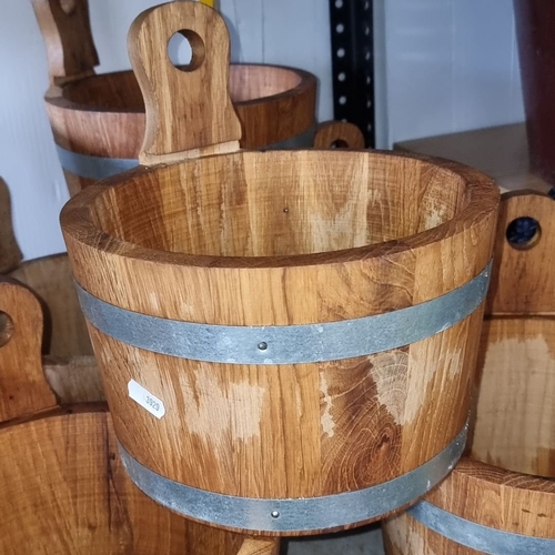 1015 - Set of eight rustic oak buckets with metal bands, featuring cut-out handles.