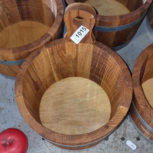 1015 - Set of eight rustic oak buckets with metal bands, featuring cut-out handles.