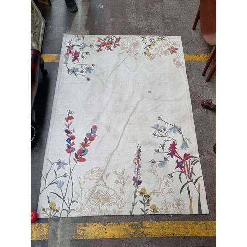 1029 - Floral wool tapestry rug features a colorful embroidered design on a cream background, showcasing in... 