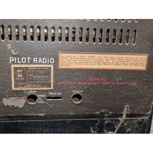 957 - Mid-century Pilot Radio Model 60 features a wooden cabinet and integrated gramophone. Manufactured b... 