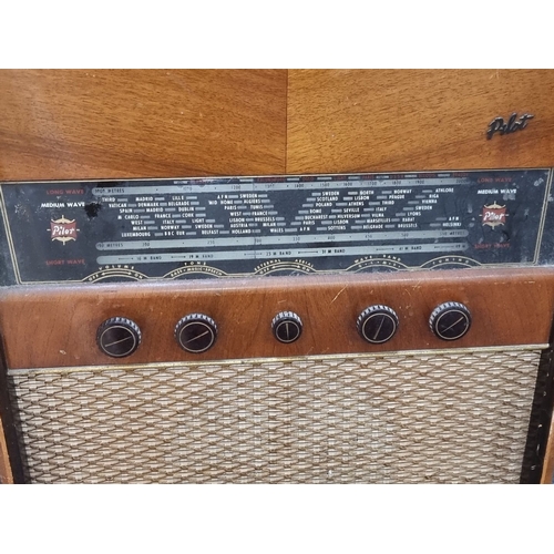 957 - Mid-century Pilot Radio Model 60 features a wooden cabinet and integrated gramophone. Manufactured b... 