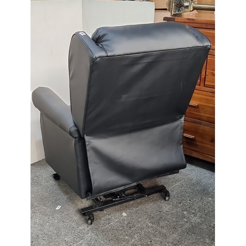 958 - Recliner chair with black upholstery features an Okin Deltadrive motor mechanism with adjustable set... 