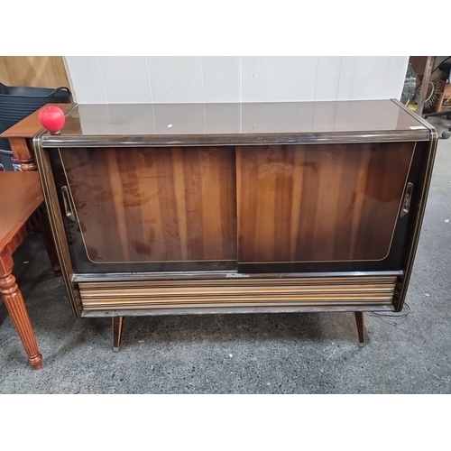 961 - Mid-century modern radiogram by Nat Ross, Cork. Features sliding doors, compact design, and distinct... 