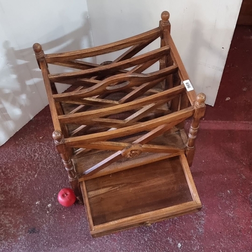 A Victorian style oak Canterbury with carved finial and drawer