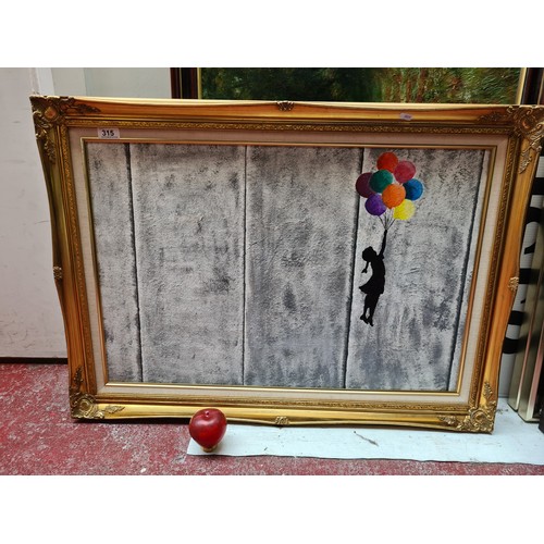 315 - A large print on canvas after an original Banksy painting titled 'Flying Balloon Girl'. Housed in a ... 