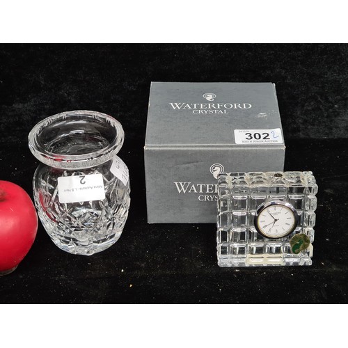 302 - Two Waterford Crystal pieces including a bud vase and desk clock. Both in good condition with acid m... 