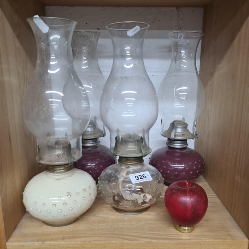 926 - Four vintage oil lamps featuring speckled detail to each reservoir and complete with original glass ... 