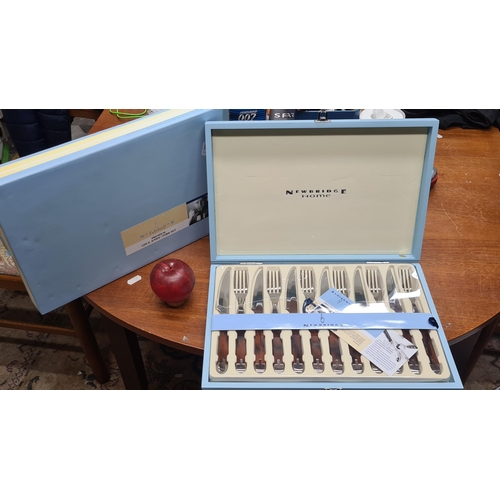 932 - A new in box Newbridge Home premium 12 piece knife/fork set.