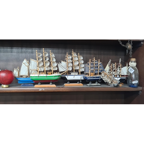 937 - A great selection of nautical themed items. Features eight model ships.