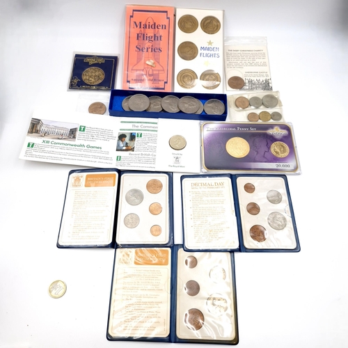 1034 - A box of commerative coins including 5 solid bronze large coins commemorating the launch of the pace... 