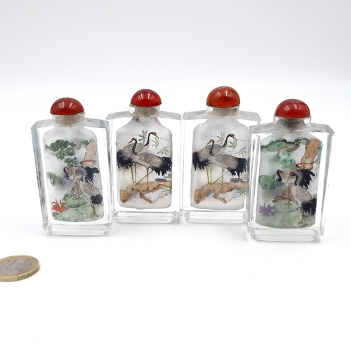 1059 - Four very pretty reverse painted Japanese Snuff bottles. With images of Cranes and other birds. All ... 