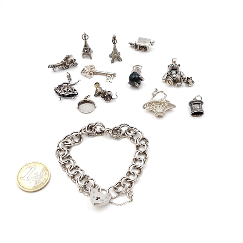 1067 - A lovely quality sterling silver double link charm bracelet with padlock clasp and 11 Sterling Silve... 