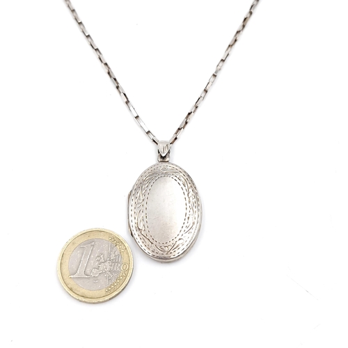 1071 - A large Sterling Silver locket with a Sterling Silver chain. 15.4g Chain 75cm long.