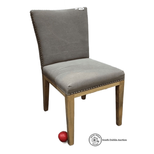 1134 - Upholstered dining chair with wooden legs, featuring nailhead trim. Approximately 32 inches high, 20... 