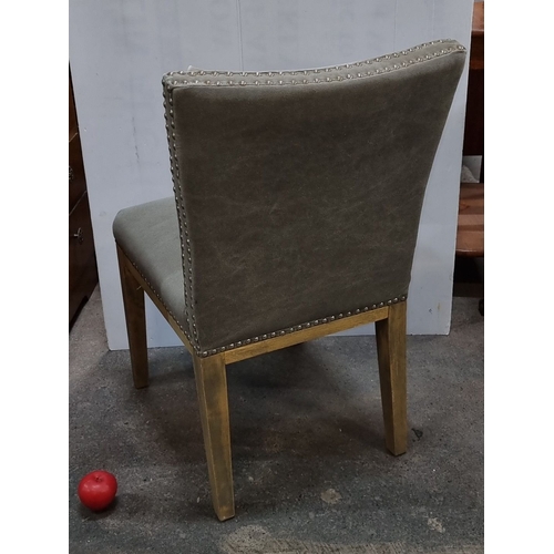 1134 - Upholstered dining chair with wooden legs, featuring nailhead trim. Approximately 32 inches high, 20... 