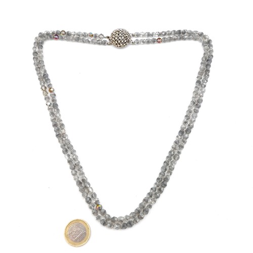 1042 - An unusual vintage double layered rock crystal beaded necklace with diamante clasp. Total weight 56.... 