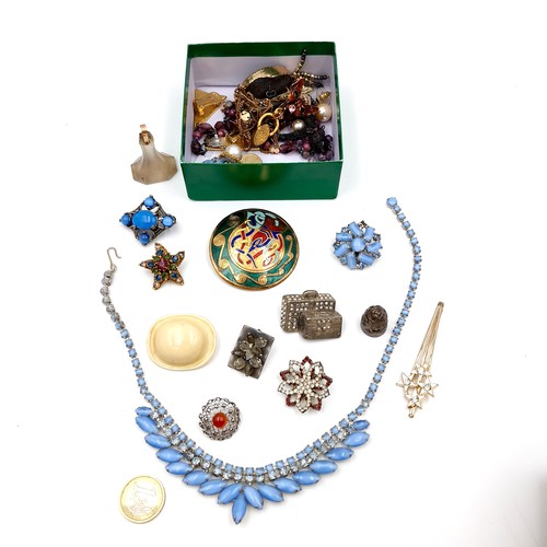 1043 - A box containing an assortment of jewellery including brooches, necklaces and earrings.