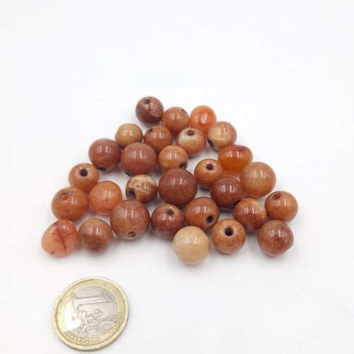 1052 - A collection of carnelian agate beads. Cold to the touch.