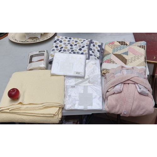 399 - A bag of mixed clothes and fabrics all in new or super condition including a new Barbour dressing go... 