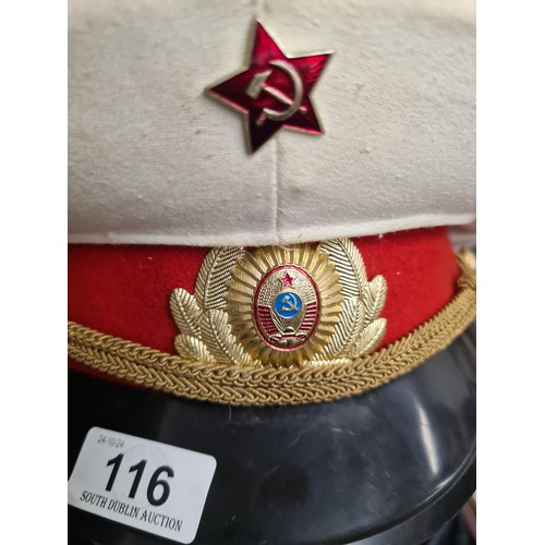 116 - A vintage Russian officers military cap with badges.