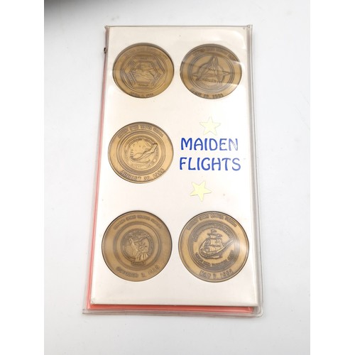 1034 - A box of commerative coins including 5 solid bronze large coins commemorating the launch of the pace... 