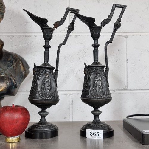 865 - A pair of tall Napoleon III ewer style pewter candlesticks. One handle has been previously repaired.